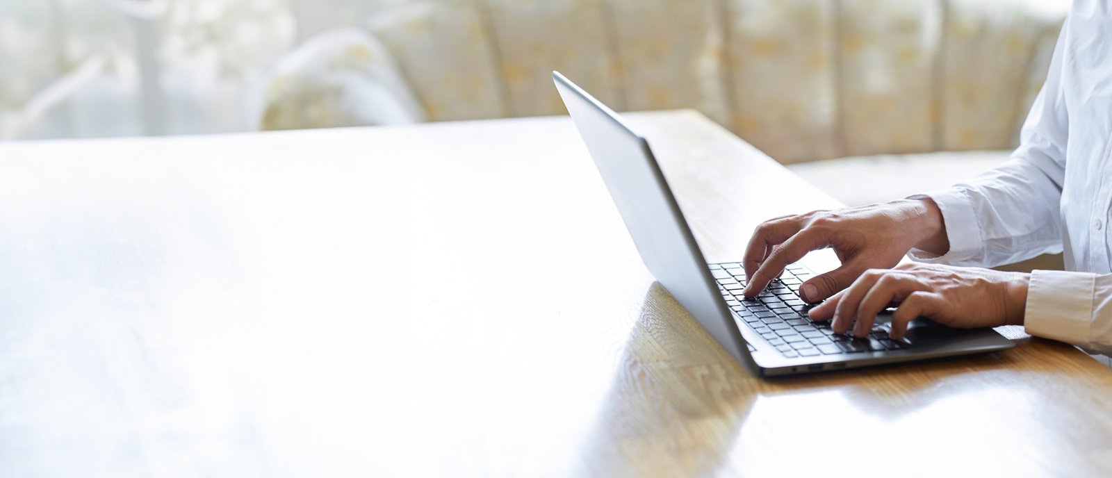Hands of a businessman typing on a laptop